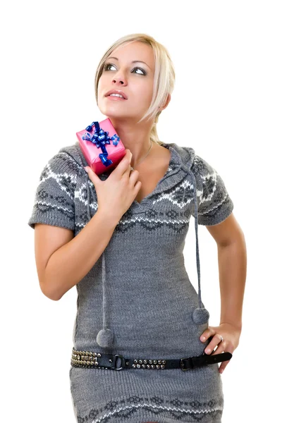 Woman holding a small pink present and thinking — Stock Photo, Image