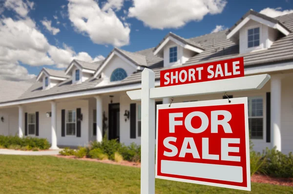 Short Sale Home For Sale Real Estate Sign and House Royalty Free Stock Images