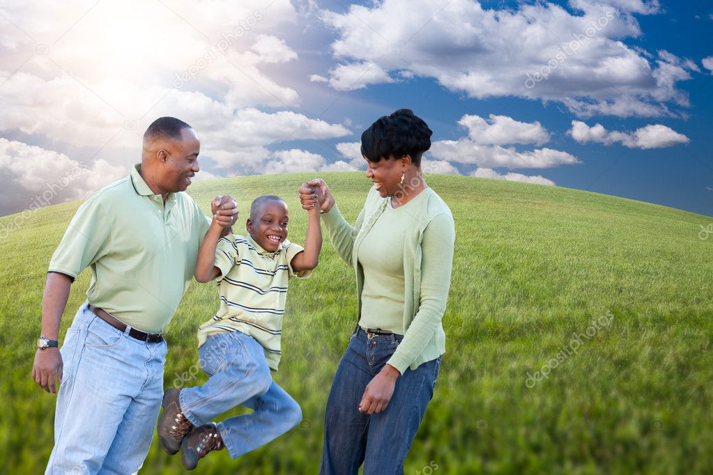Happy African American Family Playing Outdoors