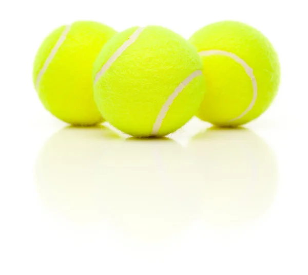 Три теннисных мяча с легким отражением на белом фоне . — стоковое фото