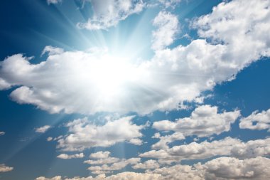 Blue Sky with Clouds and Sun Rays clipart