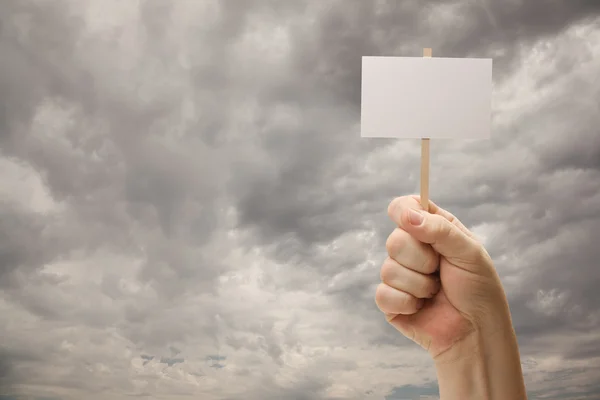 Man Holding Blank Sign Over Dramatic Storm Clouds — Stock Photo, Image