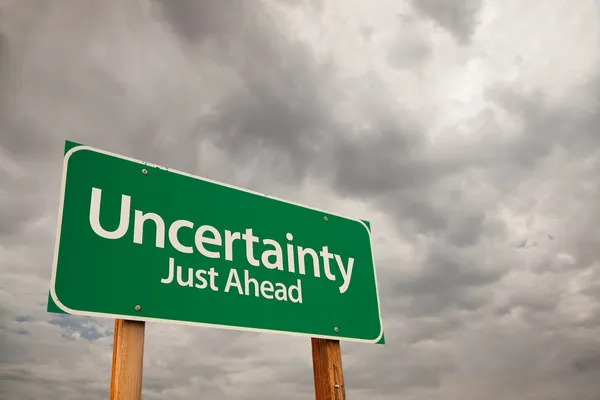 Uncertainty Green Road Sign Over Storm Clouds — Stock Photo, Image