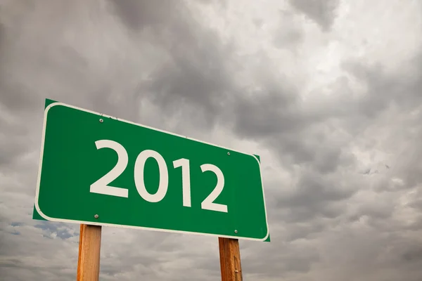 2012 Green Road Sign Over Storm Clouds — Stock Photo, Image