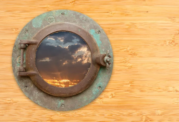 Antique Porthole with View of Sunset on Bamboo Wall — Stock Photo, Image