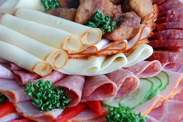 Salami and cheese rolls with vegetables — Stock Photo, Image