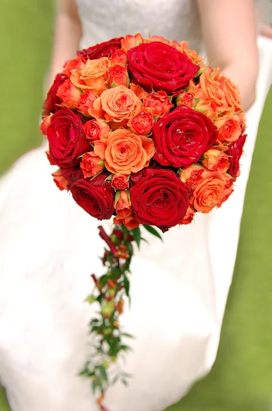 Bride holding orange bouquet — Stock Photo, Image