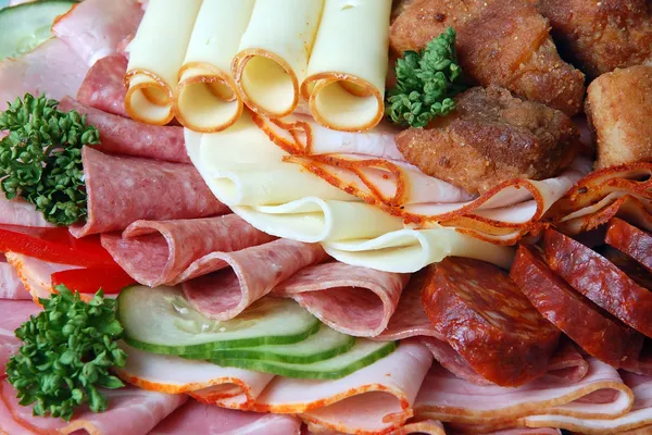 Salami and cheese rolls with vegetables — Stock Photo, Image