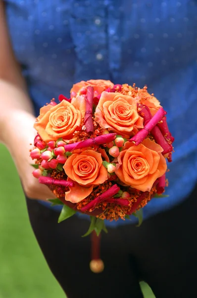 Girl holding an orange bouquet Stock Picture