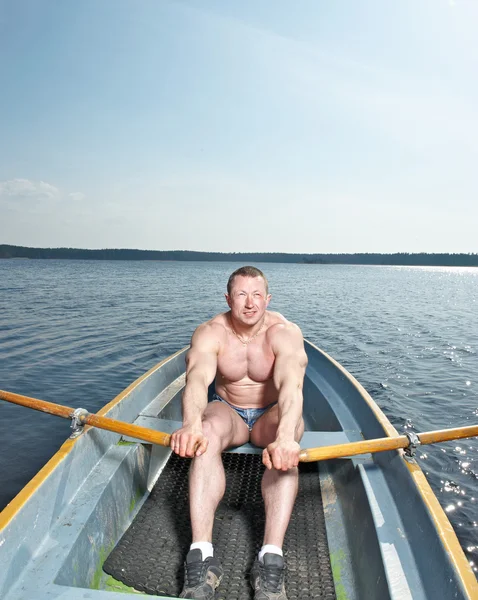 stock image Muscular man in boat