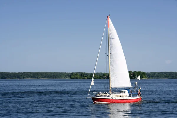 Sailing boat in blueand calm sea Stock Image