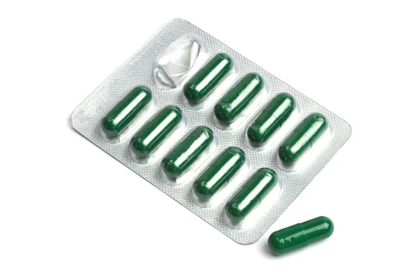 Green capsules packed in blister — Stock Photo, Image