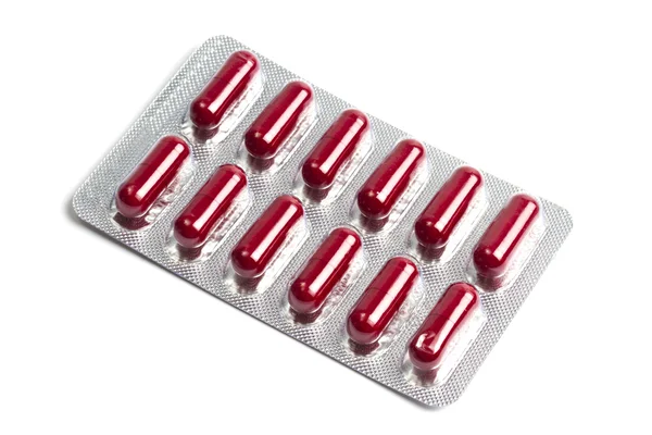 Cápsulas vermelhas embaladas em blister — Fotografia de Stock