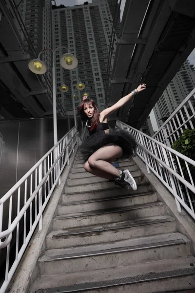 Woman jumping from a staircase — Stock Photo, Image