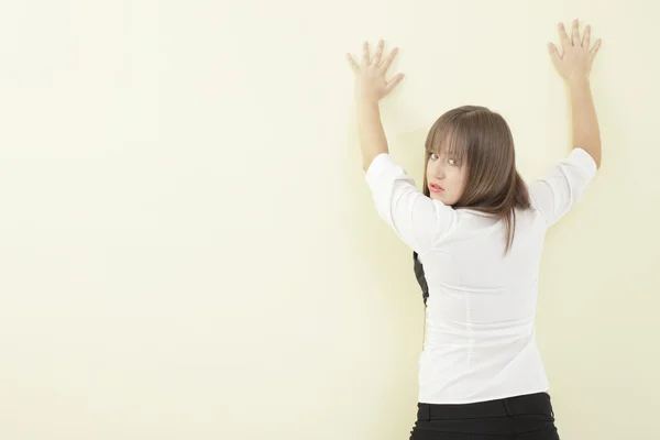 stock image Woman with hands on the wall