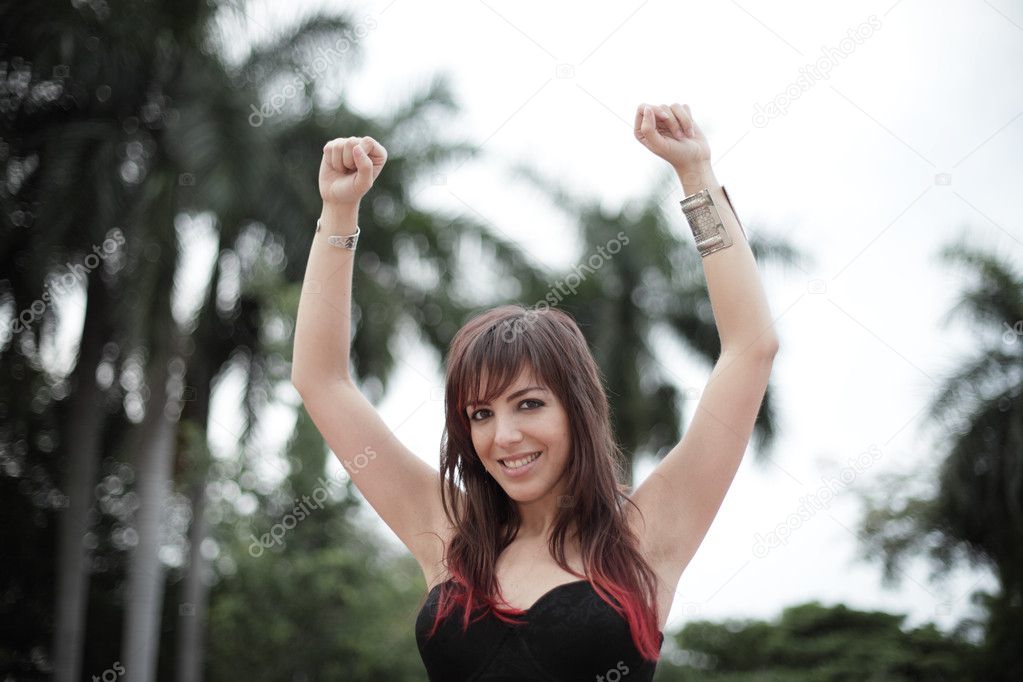 Happy woman with arms raised