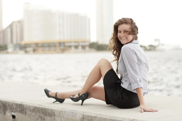 Attraktive junge Frau sitzt an der Bucht — Stockfoto
