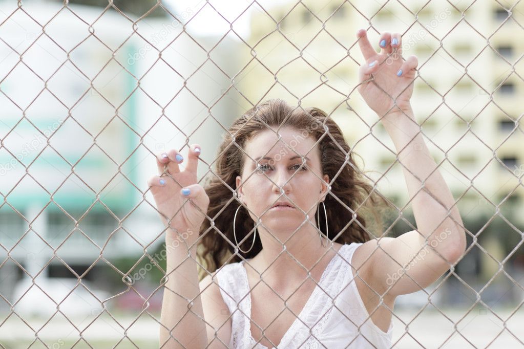 Young female model on the fence