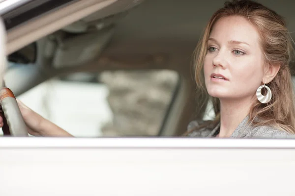 Woman looking out of her car window — Stock Photo, Image
