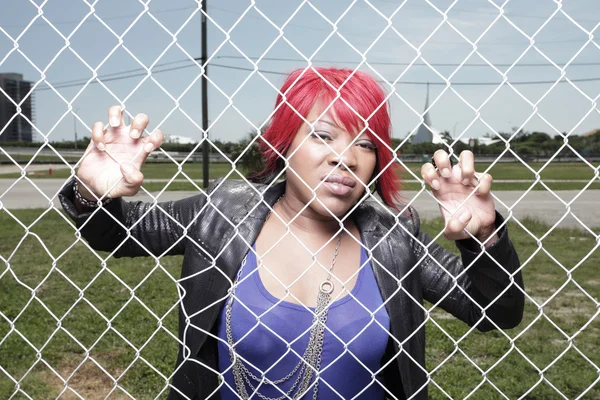 Fashionable woman behind the fence — Stock Photo, Image