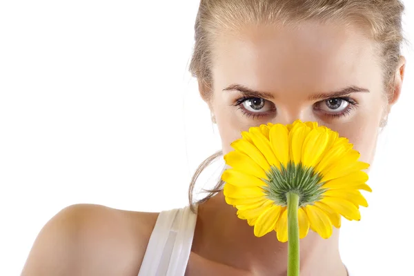 Smelling a yellow flower — Stockfoto