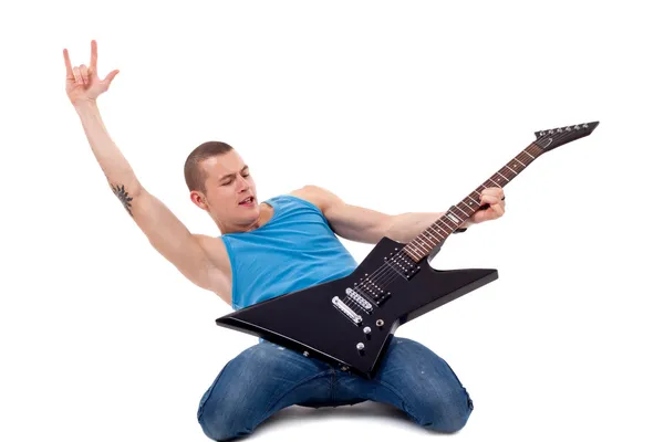 Spelar gitarr på knäna — Stockfoto