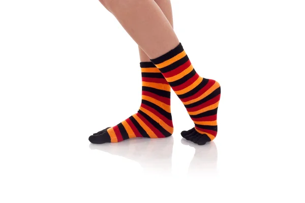 Woman legs in strip socks — Stock Photo, Image