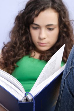 Teenage girl reading a book clipart