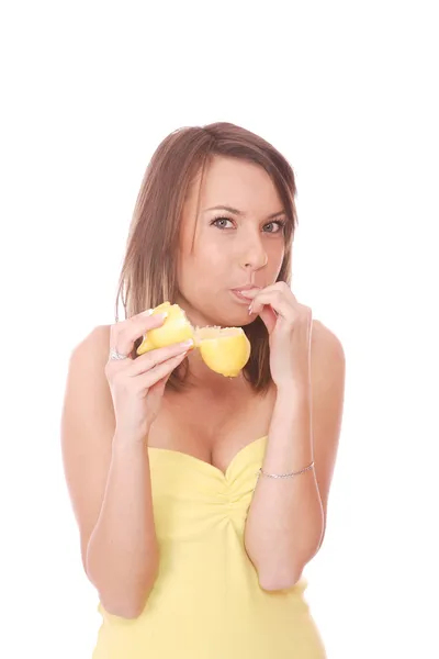 Jovem mulher comendo limão azedo — Fotografia de Stock