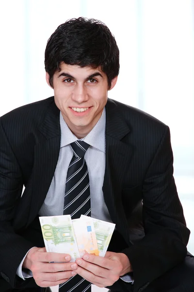Businessman holds money — Stock Photo, Image