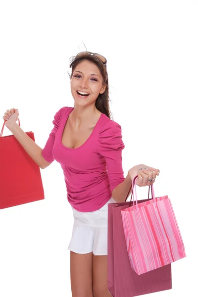 Šťastná žena s růžovými nákupní tašky — Stock fotografie