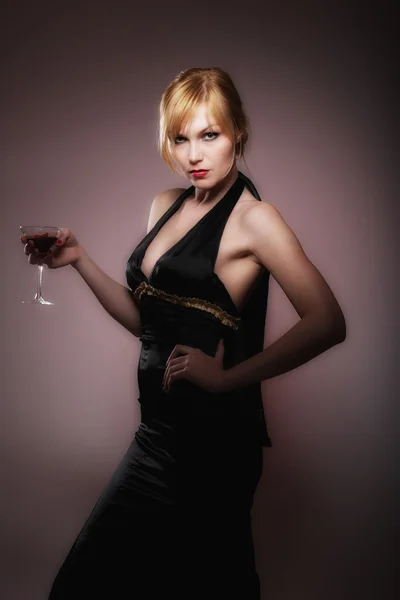 Vacker blond kvinna med glas Royaltyfria Stockfoton