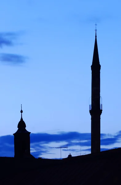 Minaret and church tower — Stock Photo, Image