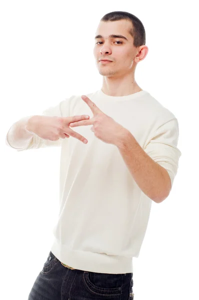 Jeune homme montrant signe sur fond blanc — Photo