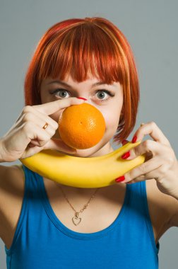 Red-haired girl with banana and orange clipart