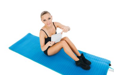 Beautiful red girl exercising with a plan clipart