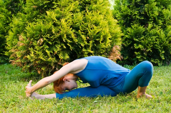 Beautiful red woman doing fitness or yoga exerci — Stock Photo, Image