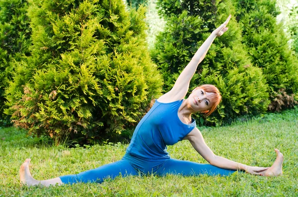 Mulher vermelha bonita fazendo fitness ou ioga exerci — Fotografia de Stock