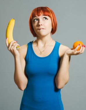 Red-haired girl with banana and orange clipart