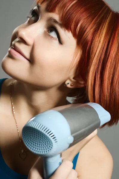 stock image Woman with hairdryer and a hairbrush
