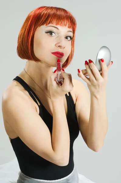Red girl with lipstick and mirror — Stock Photo, Image