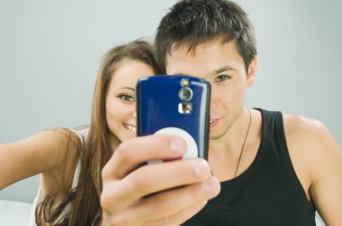 Happy couple taking a photo clipart