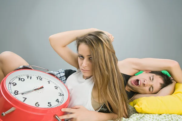 Young couple with alarm clock — Stock Photo, Image