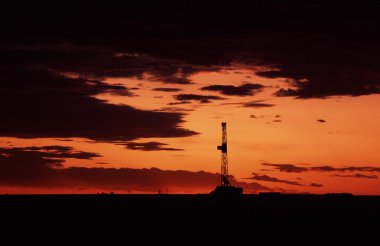 Oil rig at sunset clipart