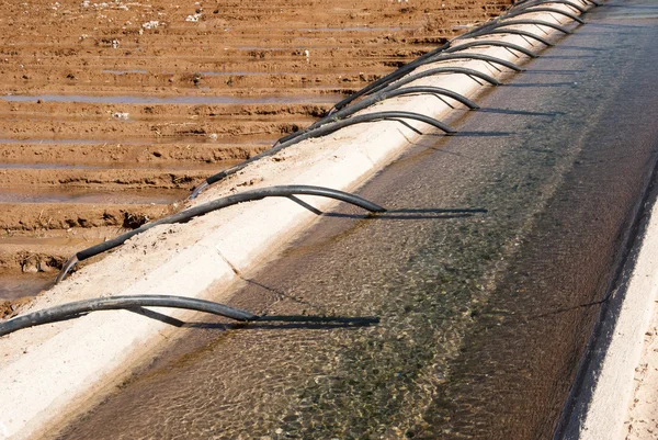 Irrigation canal & siphon tubes — Stock Photo, Image