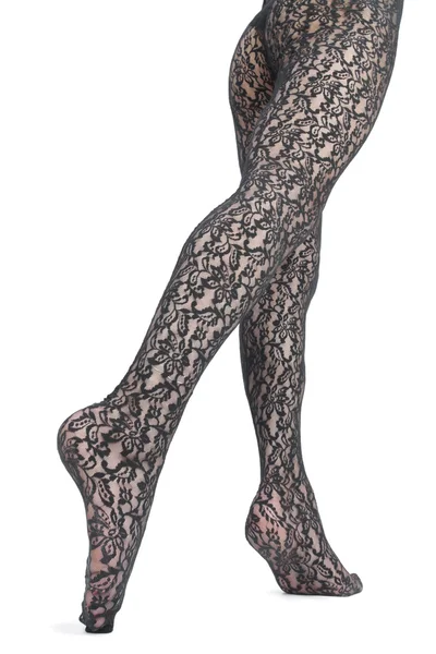 Kvinna ben och fötter med spets tights — Stockfoto
