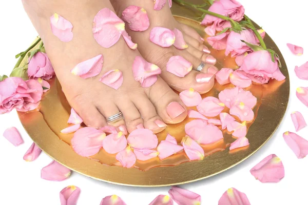 Woman feet with flowers and petals — Stock Photo, Image