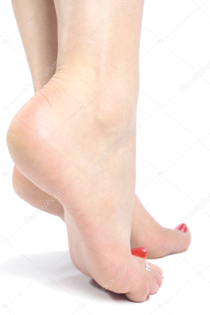 Woman feet with pink flower over white