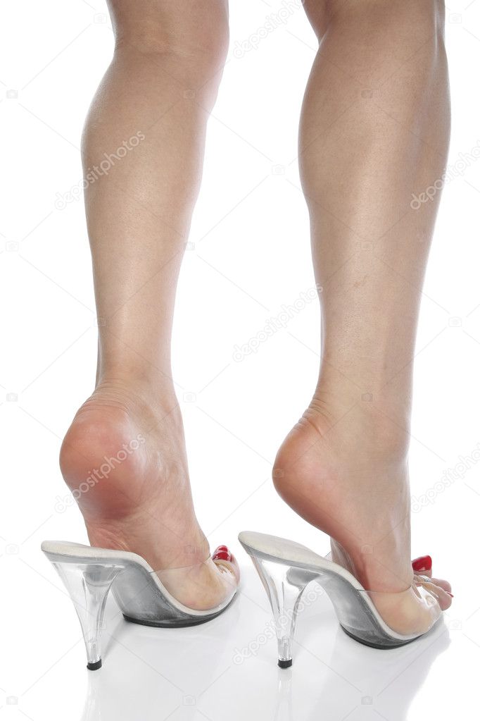 Woman legs and high heel shoes over white