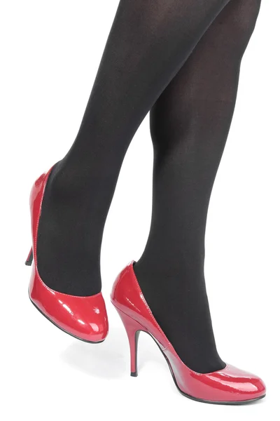 Collants jambes femme avec talons rouges sur blanc — Photo